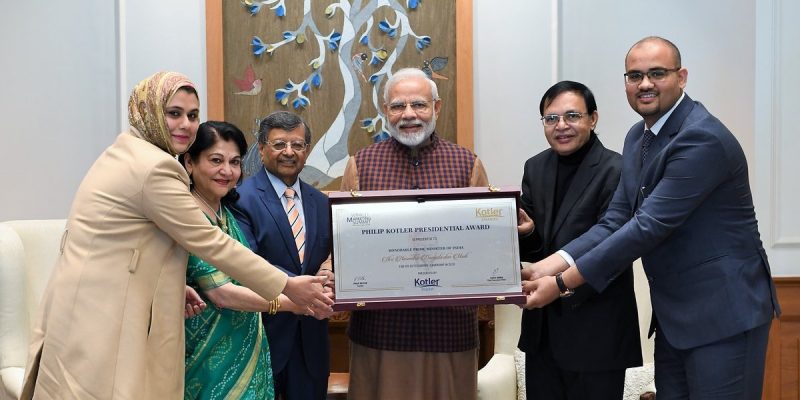 Indian Prime Minister receving award from Kotler Team